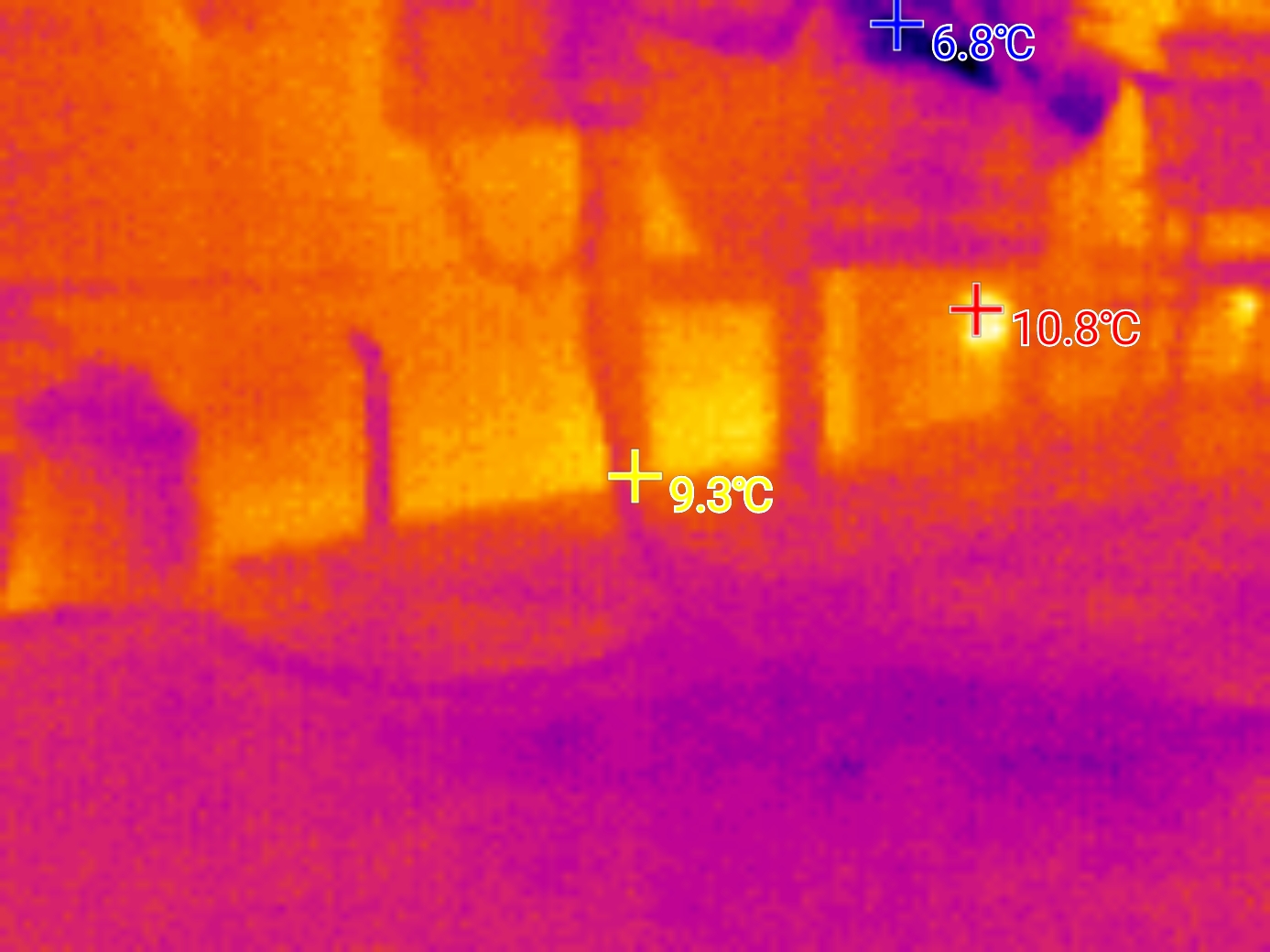Thermal image of an external brick wall and foundation